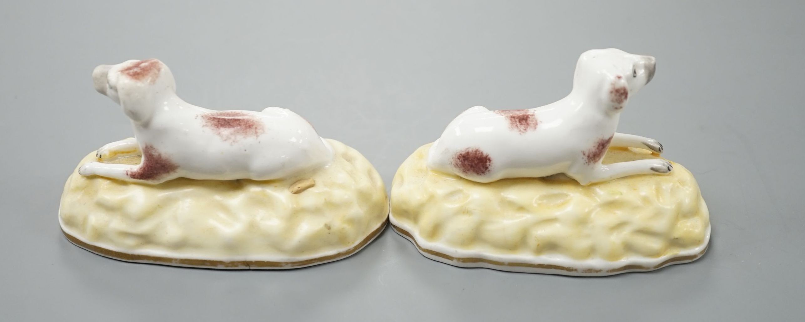 A rare pair of Samuel Alcock porcelain models of recumbent pointers, c.1835–50, impressed mark ‘115’, 8.8 cm long, Unrecorded in Dennis G.Rice Dogs in English porcelain., Provenance: Dennis G.Rice collection